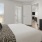 a bedroom with a bed and a fan