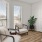 a room with a table chairs and a window with blinds