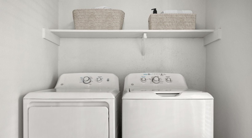 a white washing machine and a shelf