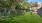 a fenced in yard with a bench and trees