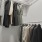 a room with a rack of clothes